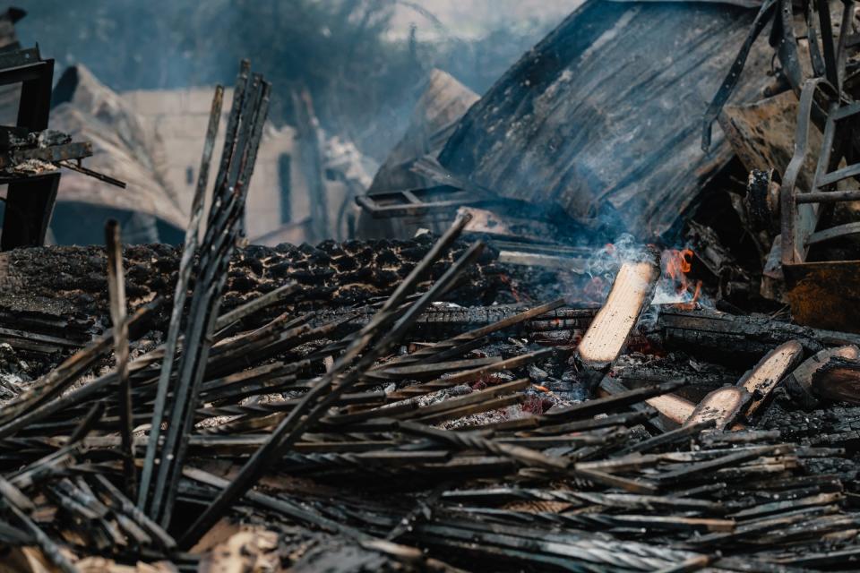 Spot fires continue to smolder at Lincolns and Things, Tuesday, Dec. 7, 2021 in Sherrodsville. A fire yesterday afternoon leveled the structure, which also warehoused approximately $8000 worth of toys for the Tuscarawas County Toys for Tots program.