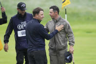 Argentina's Emiliano Grillo, left shakes hands with Northern Ireland's Rory McIlroy as they complete their round on the 18th green during the final day of the British Open Golf Championships at the Royal Liverpool Golf Club in Hoylake, England, Sunday, July 23, 2023. (AP Photo/Kin Cheung)