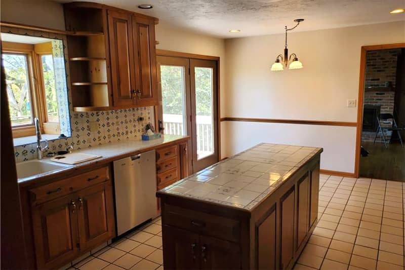 Tiled island in kitchen before renovation.