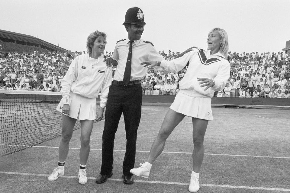 FILE - In this July 4, 1985, file photo, Chris Evert, left, and Martina Navratilova joke with Police Constable Les Bowie on Number Two Court at Wimbledon, England. Navratilova successfully defended her title against Evert on July 6, 1985. (AP Photo/Dave Caulkin, File)
