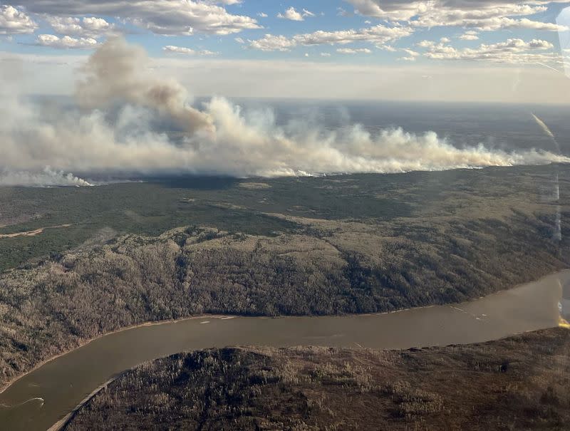FILE PHOTO: Smoke rises from a wildfire on the south side of the Athabasca River valley near Fort McMurray