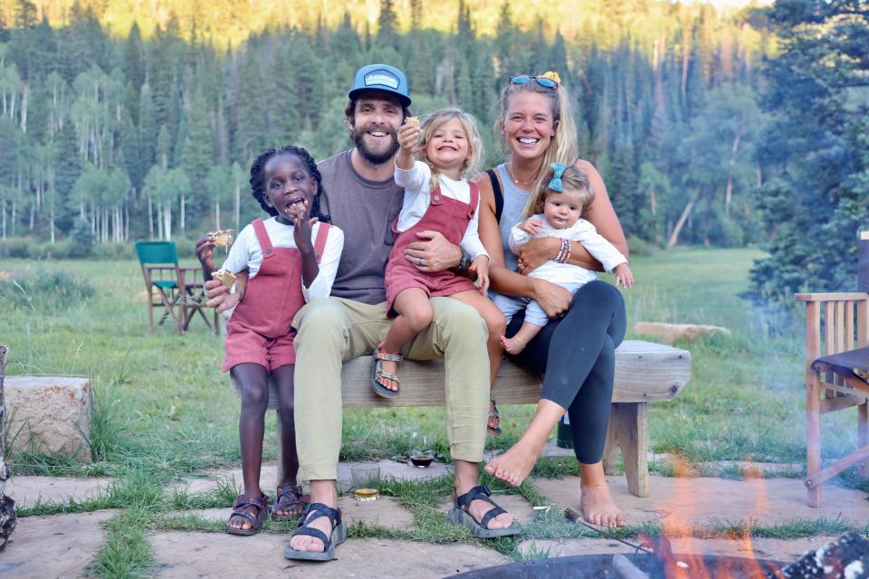 Lauren Akins and her husband, Thomas Rhett, pose with their kids during a backyard s'mores adventure in 2020. The children, from left, are Willa Gray, Ada James and Lennon Love.