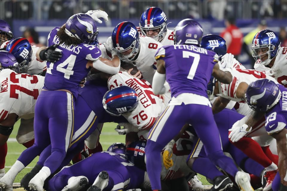 Daniel Jones, quarterback de los Giants de Nueva York, convierte un primero y diez en acarreo personal durante la segunda mitad del juego de playoffs contra los Vikings de Minnesota, en la Ronda de Comodines de la Conferencia Nacional, el domingo 15 de enero de 2023, en Minneapolis. (AP Foto/Bruce Kluckhohn)