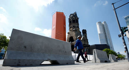 FILE PHOTO: Concrete barriers are pictured at the same site where on December 19, 2016 a truck ploughed through a crowd at a Christmas market on Breitscheidplatz square near Kurfuerstendamm avenue ahead of the German protestant church congress (Kirchentag) in Berlin, Germany, May 23, 2017. REUTERS/Fabrizio Bensch/File Photo