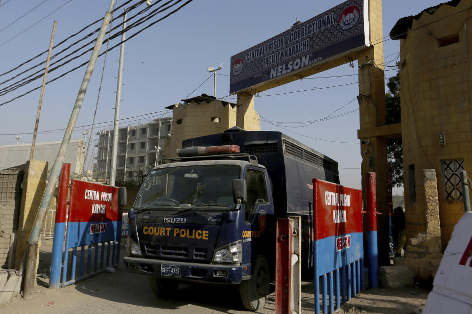 A police van is driven out from the Karachi Central Prison where British-born Pakistani Ahmed Omar Saeed Sheikh, who was charged, convicted and later acquitted in the 2002 murder of American journalist Daniel Pearl, is detained, in Karachi, Pakistan, Friday, Jan. 29, 2021. Pakistan is scrambling to manage the fallout of a Supreme Court decision to free the Pakistani-British man accused in the 2002 beheading of American Journalist Daniel Pearl. The Sindh Provincial government on Friday filed a review petition, asking the same court to revisit its decision. (AP Photo/Fareed Khan)