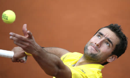 Marin Cilic of Croatia serves to Andrea Arnaboldi of Italy during their men's singles match at the French Open tennis tournament at the Roland Garros stadium in Paris, France, May 28, 2015. REUTERS/Gonzalo Fuentes