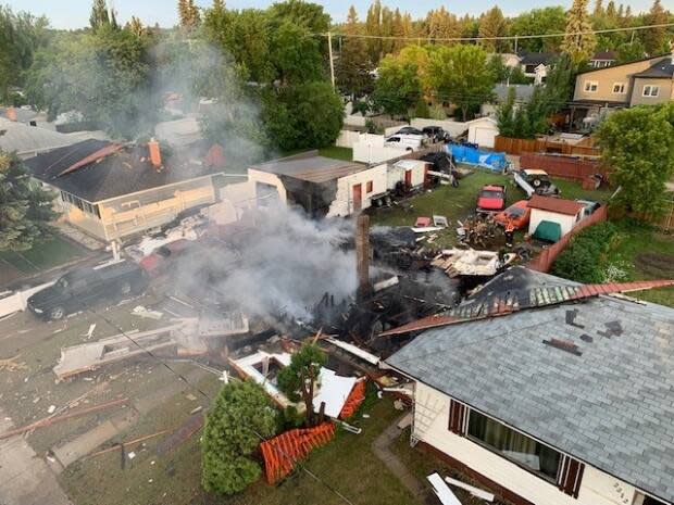 The cause of the explosion and the extent of damage to neighbouring homes are still under investigation, the Saskatoon Fire Department says. (Submitted by Saskatoon Fire Department - image credit)