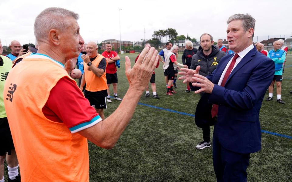 Sir Keir Starmer meets a member of a walking football team during their weekly session at the Anfield Sport & Community Centre in Liverpool yesterday - Danny Lawson/PA