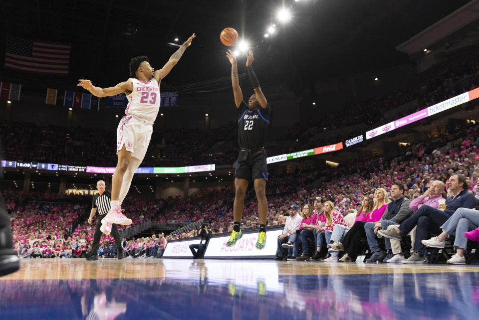 DePaul's Elijah Fisher (22) shoots a 3-pointer against Creighton's Trey Alexander (23) during the first half of an NCAA college basketball game Saturday, Jan. 27, 2024, in Omaha, Neb. (AP Photo/Rebecca S. Gratz)