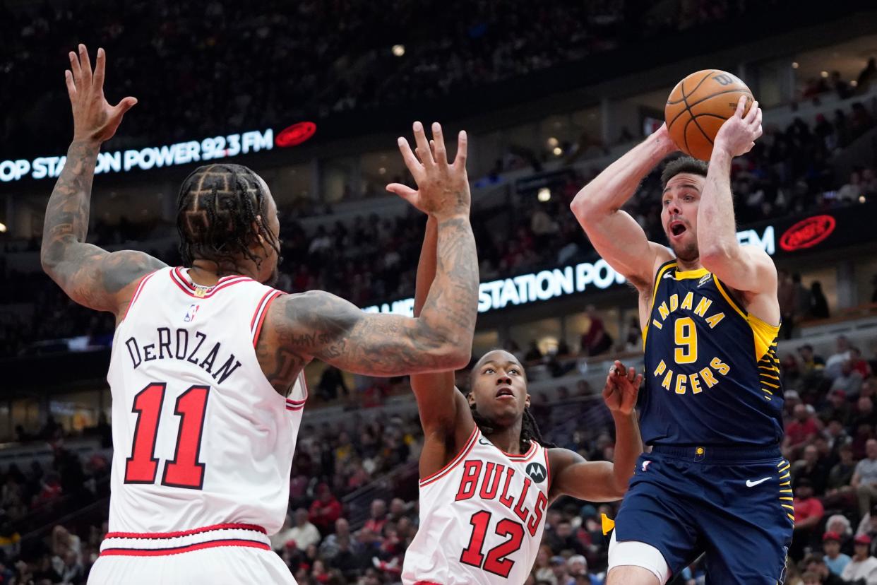 Mar 27, 2024; Chicago, Illinois, USA; Chicago Bulls forward DeMar DeRozan (11) defends Indiana Pacers guard T.J. McConnell (9) during the first quarter at United Center. Mandatory Credit: David Banks-USA TODAY Sports