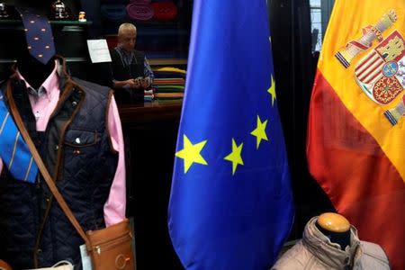 A shopkeeper waits for customers at a store in Madrid, Spain April 4, 2017. REUTERS/Susana Vera