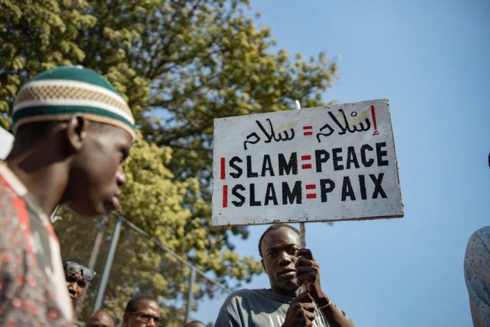 A man holds up a sign &quot;Islam = peace&quot; during an anti-blasphemy protest in Bamako on November 04, 2022, amid High Islamic Council of Mali calls protest after viral video of man &quot;insulting&quot; the Koran.