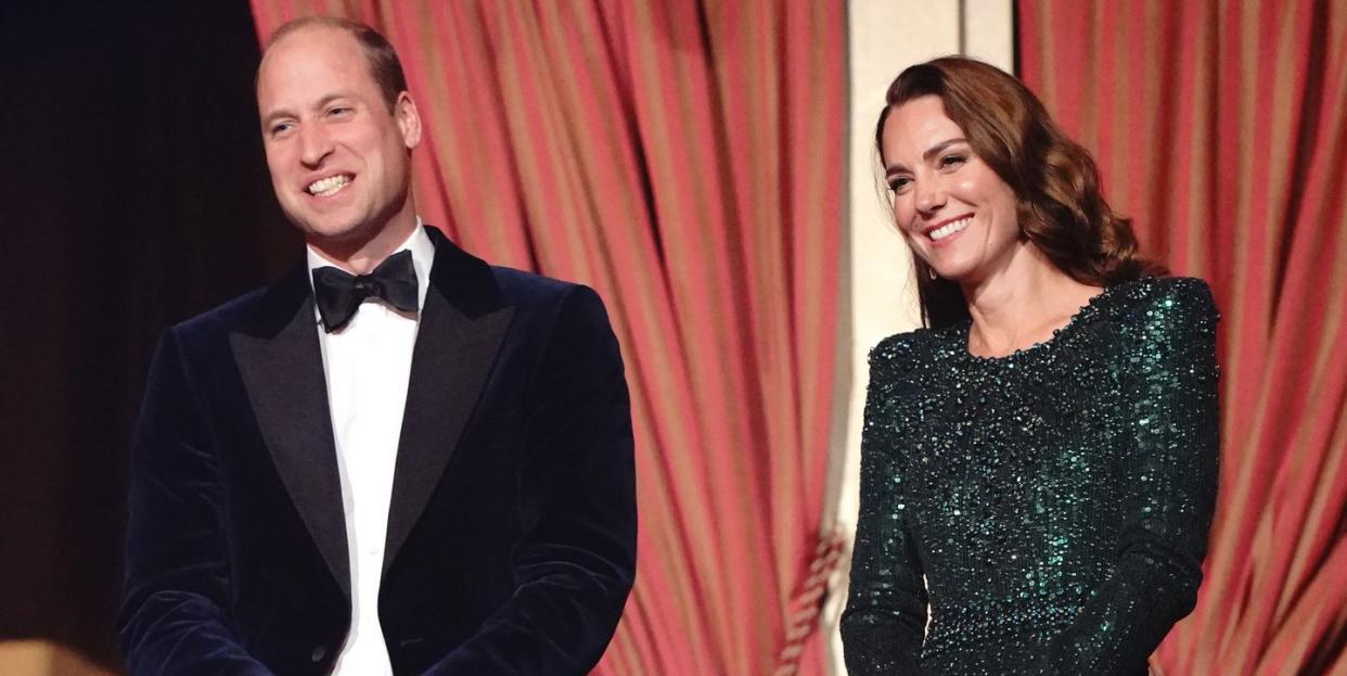 duke and duchess of cambridgestand on a balcony smiling at the royal variety performance