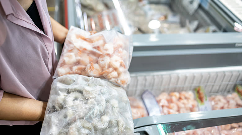 person holding frozen seafood packages