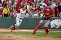 North Carolina State's Austin Murr (12) and Luca Tresh (24) celebrate after making the final out to beat Arkansas 3-2 to advance to the College World Series during an NCAA college baseball super regional game Sunday, June 13, 2021, in Fayetteville, Ark. (AP Photo/Michael Woods)