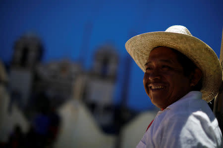 Cruz Gomes, a 44-year-old migrant from Guatemala, part of a caravan of thousands from Central America en route to the United States, smiles while rests in Santiago Niltepec, Mexico October 29, 2018. REUTERS/Ueslei Marcelino