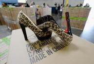 More than 20,000 pairs of counterfeit Louboutin pumps and high heels featuring the distinctive red sole of French designer Christian Louboutin are displayed at Price Transfer Warehouse on August 16, 2012 in Long Beach, California. Between July 27 and Aug. 14, import specialists and officers assigned to the Los Angeles and Long Beach seaport have seized a total of five shipments from China containing more than 20,000 pairs in violation of the French designer's trademark with a potential retail value of $18 million.