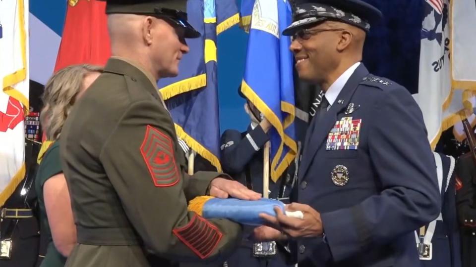 Chairman of the Joint Chiefs of Staff Gen. CQ Brown presents Senior Enlisted Adviser to the Chairman Troy Black with the SEAC flag at his installation ceremony Nov. 3, 2023, at Joint Base Myer-Henderson Hall, Virginia. (Screenshot of DOD livestream)