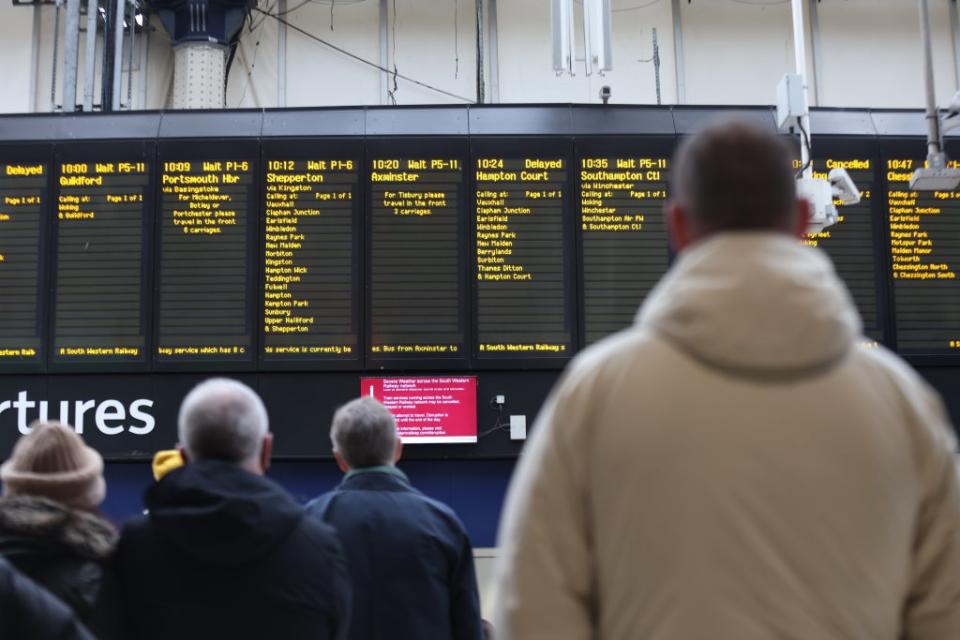 Passengers wait at Waterloo railway station, London, for delayed trains amid cancellations on several services (James Manning/PA) (PA Wire)