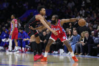 Philadelphia 76ers' James Harden (1) fends off Toronto Raptors' Scottie Barnes during the first half of an NBA basketball game Friday, March 31, 2023, in Philadelphia. (AP Photo/Matt Rourke)