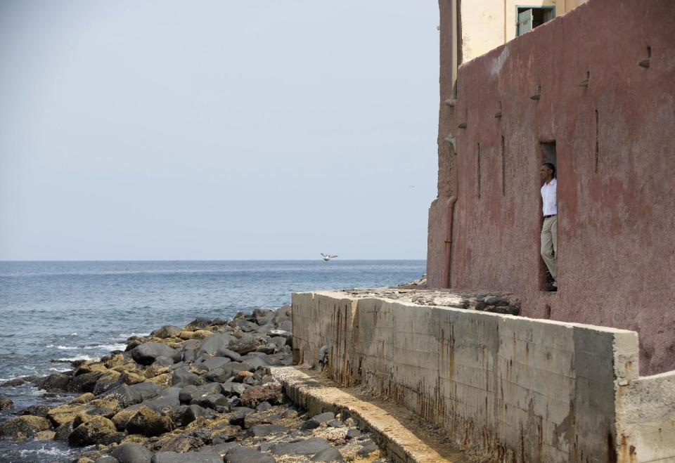 President Barack Obama looks out of the "door of no return" during a tour of Goree Island, Thursday, June 27, 2013, in Goree Island, Senegal. Goree Island is the site of the former slave house and embarkation point built by the Dutch in 1776, from which slaves were brought to the Americas. The "door of no return" was the entrance to the slave ships. (AP Photo/Evan Vucci)