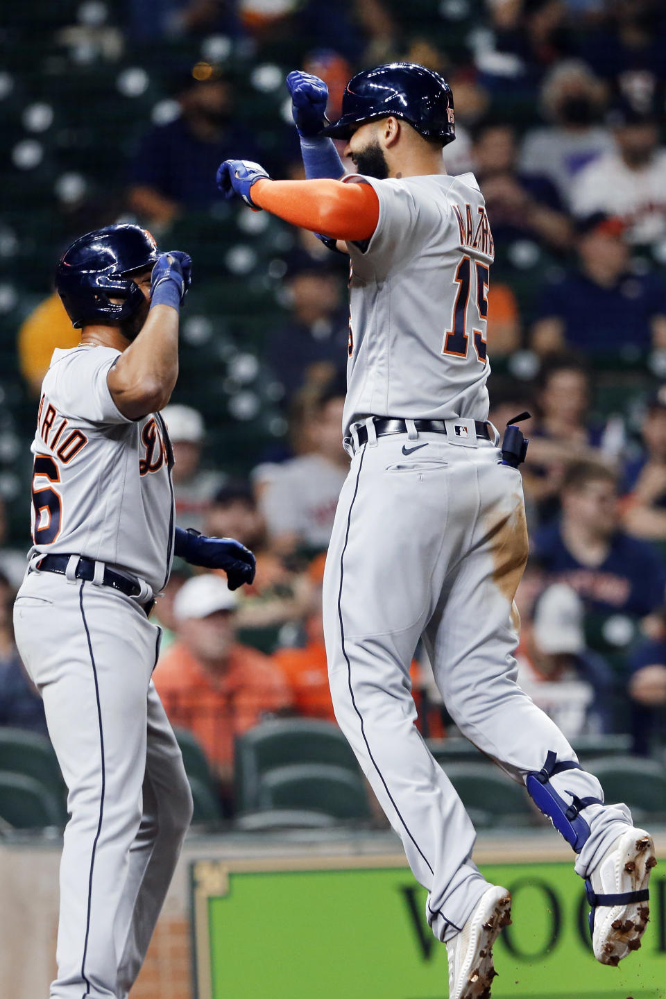 Detroit Tigers' Jeimer Candelario, left, and Nomar Mazara (15) celebrate at the plate after they scored Mazara's home run against the Houston Astros during the fourth inning of a baseball game Tuesday, April 13, 2021, in Houston. (AP Photo/Michael Wyke)