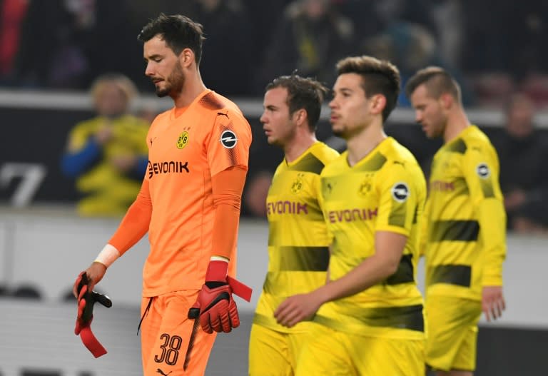 (L-R) Dortmund's Roman Buerki, Mario Goetze, Raphael Guerreiro and Andrey Yarmolenko react after their German first division Bundesliga match against Stuttgart, in Stuttgart, on November 17, 2017