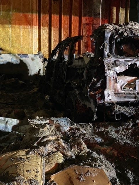 What remained of a 2021 Ford Expedition owned by Brian Nowak and Erin Walker after it caught fire Nov. 29, 2021 in their attached garage at home in Wadsworth, Ohio.