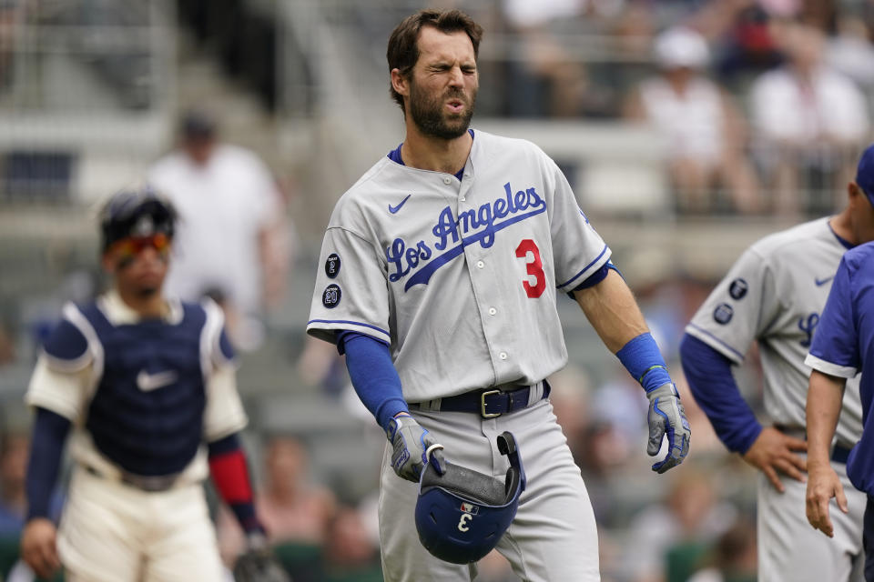 Los Angeles Dodgers' Chris Taylor (3) reacts after fouling a pitch off his foot in the fourth inning of a baseball game against the Atlanta Braves, Sunday, June 6, 2021, in Atlanta. Taylor remained in the game. (AP Photo/Brynn Anderson)