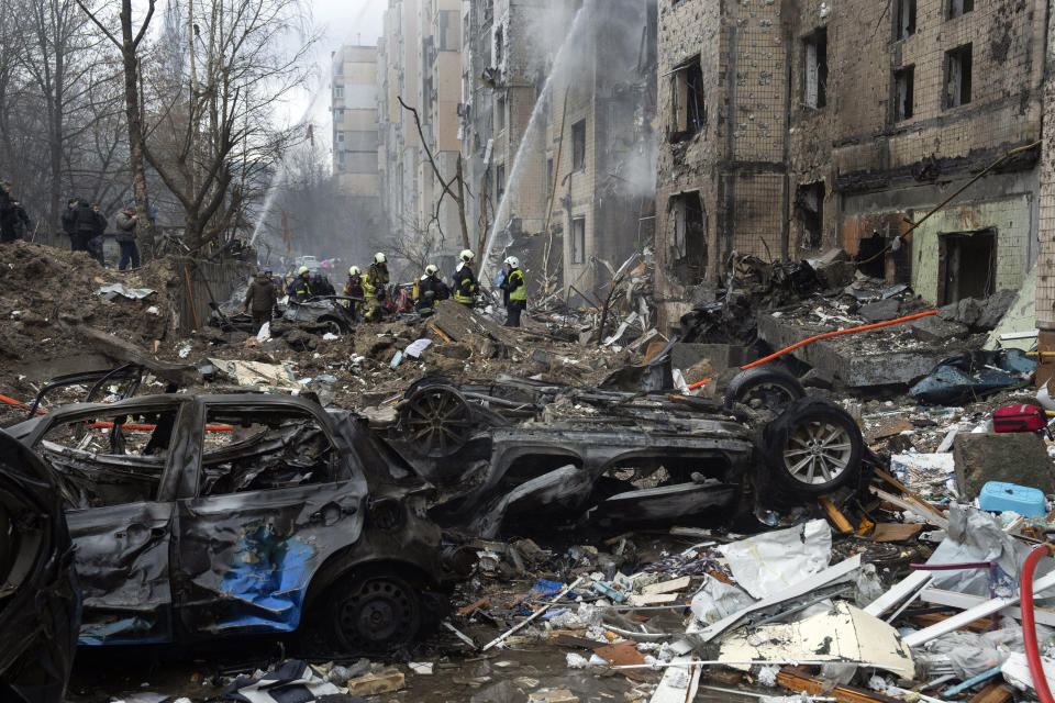 Firefighters work to extinguish a fire in a destroyed apartment building after a Russian attack in Kyiv, Ukraine, Tuesday, Jan. 2, 2024. (AP Photo/Efrem Lukatsky)