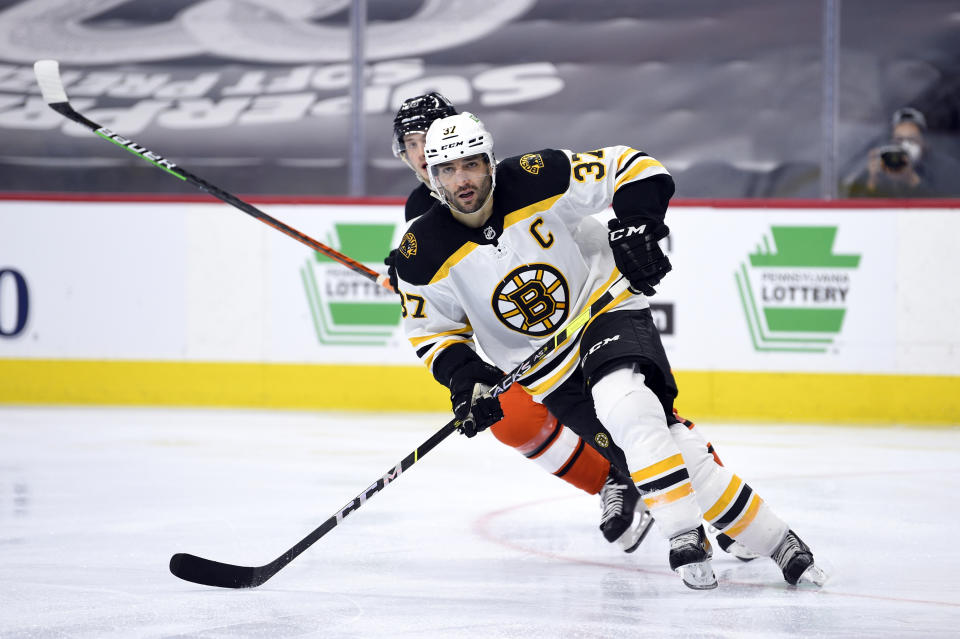 Boston Bruins' Patrice Bergeron skates up ice ahead of Philadelphia Flyers' Joel Farabee during the second period of an NHL hockey game, Saturday, April 10, 2021, in Philadelphia. (AP Photo/Derik Hamilton)