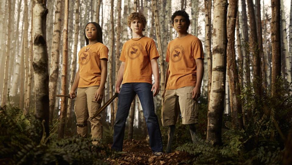 Annabeth, Percy, and Grover stand in the woods of Camp Half Blood in Percy Jackson and the Olympians, which has been renewed for season two