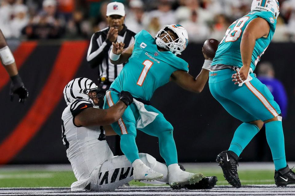 Bengals DT Josh Tupou (68) sacks Dolphins QB Tua Tagovailoa on Thursday, leaving him concussed and sending the third-year passer to a local hospital.