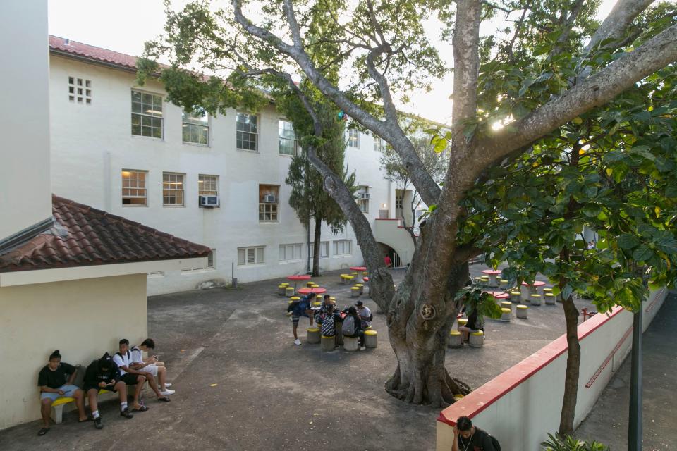 Students mingle in a courtyard before the start of the school day at Roosevelt High School.