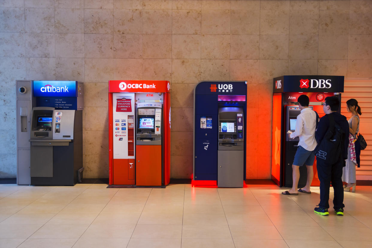 A row of automated teller machines (ATMs) from various local banks at Changi Airport, illustrating a story on Money Lock.