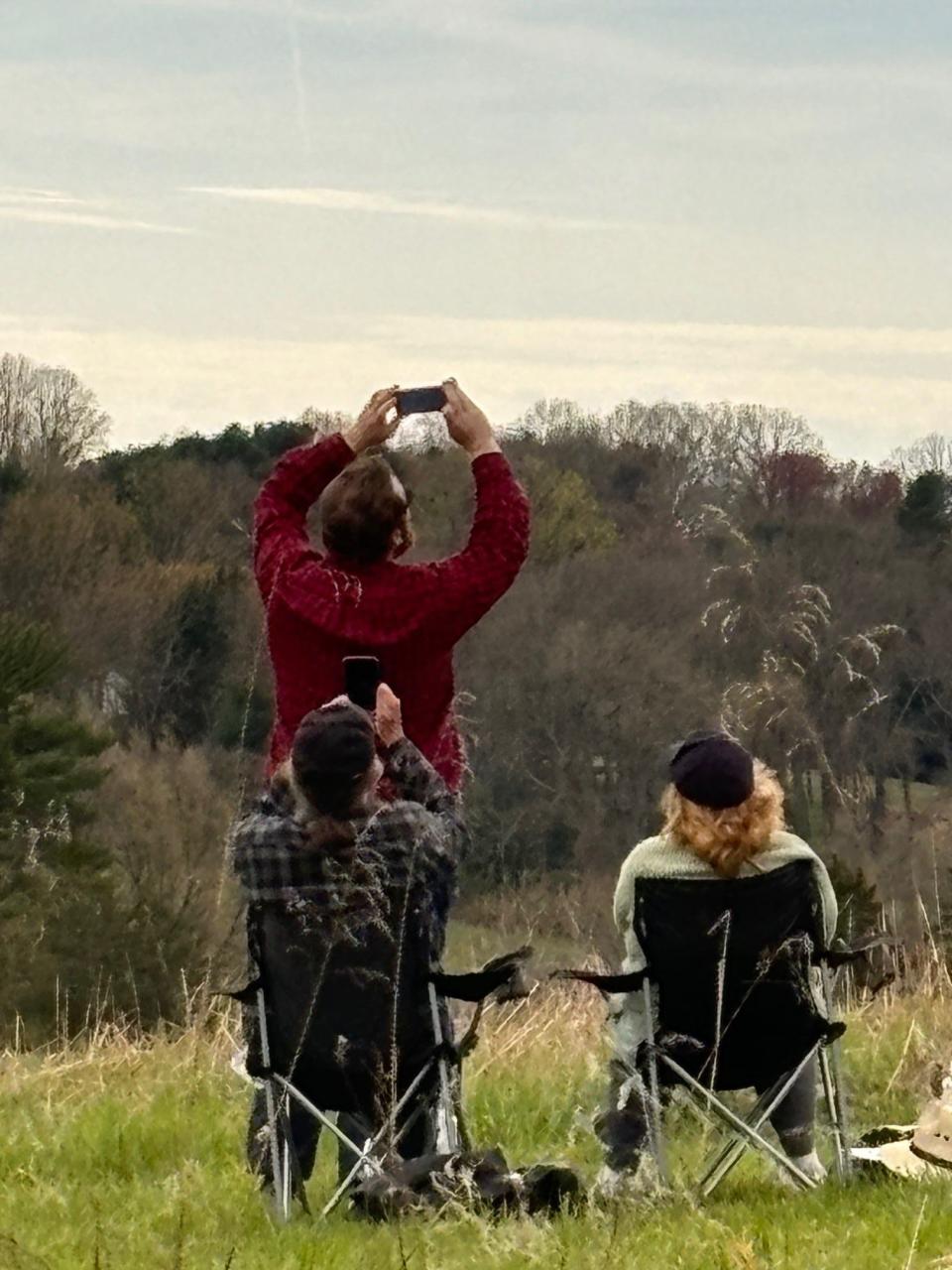 Many people in the crowd of more than 100 people at Auburn Heights Preserve in Yorklyn had their phones ready to snap photos when the clouds cleared and the sun came out just in time to see the eclipse on Monday afternoon.