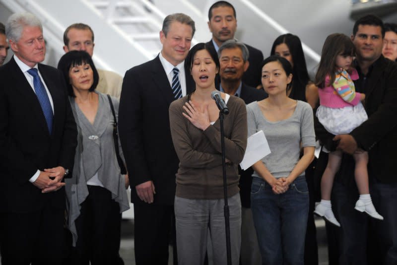 Euna Lee (L) and Laura Ling (R), two American journalists who were arrested in March after allegedly crossing into North Korea from China, speak with reporters as former President Bill Clinton and former Vice President Al Gore look on after the two arrived at Bob Hope Airport in Burbank, Calif., on August 5, 2009. North Korea sentenced Lee and Ling to 12 years of hard labor on June 8, 2009. File Photo by Jim Ruymen/UPI