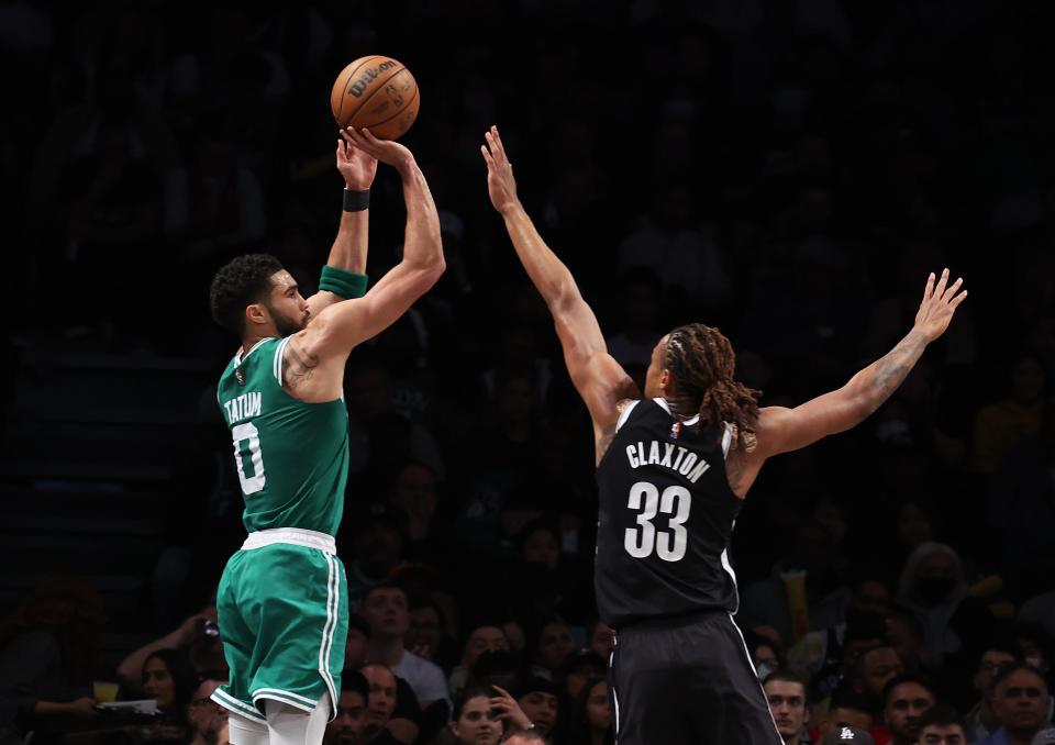 Jayson Tatum of the Boston Celtics shoots against Nic Claxton of the Brooklyn Nets during Game Three of the Eastern Conference First Round NBA Playoffs at Barclays Center on April 23, 2022 in New York City.