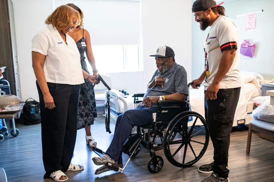 Chet Lemon, center, dances along as his wife, Gigi Lemon, left, plays a music video next to their daughter Brianna Lemon, center left, and son Marcus Lemon, right, at Encompass Health Rehabilitation Hospital in Clermont, Fla., on Thursday, May 23, 2024.