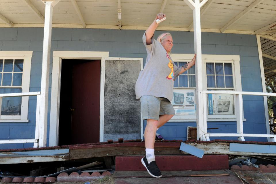 The day after the July 5, 2019, earthquake, Jamie Lacevedo attempts to navigate her porch steps after the foundation of her house in Trona was warped by the 7.1 magnitude quake.