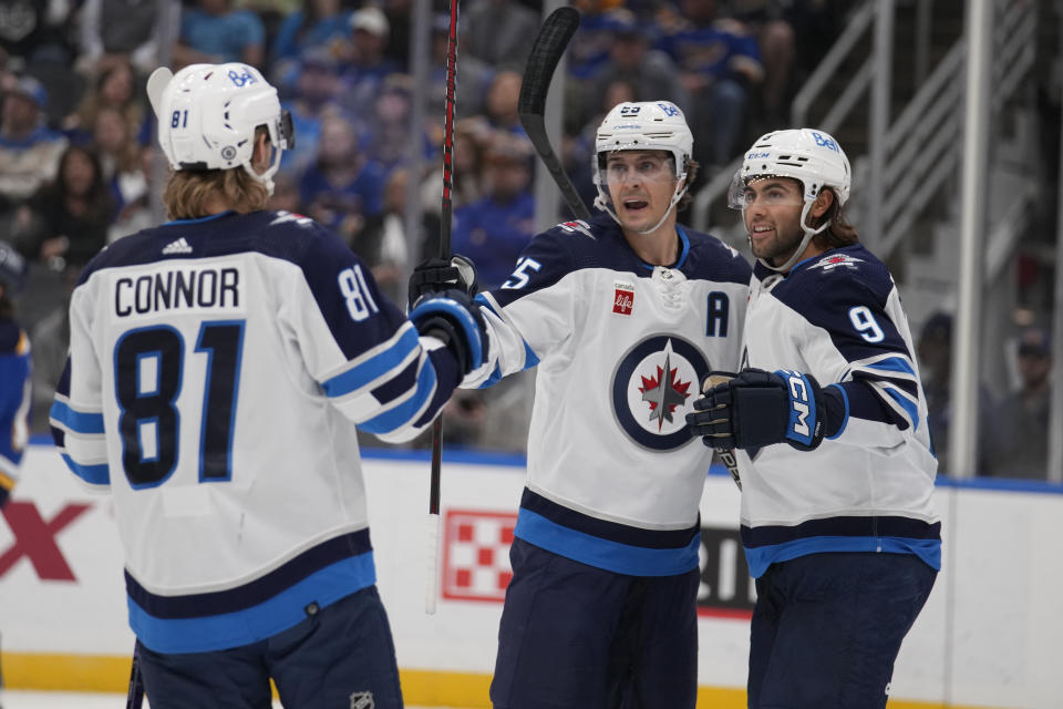 Winnipeg Jets' Mark Scheifele (55) is congratulated by Kyle Connor (81) and Alex Iafallo (9) after scoring during the first period of an NHL hockey game against the St. Louis Blues Tuesday, Nov. 7, 2023, in St. Louis. (AP Photo/Jeff Roberson)