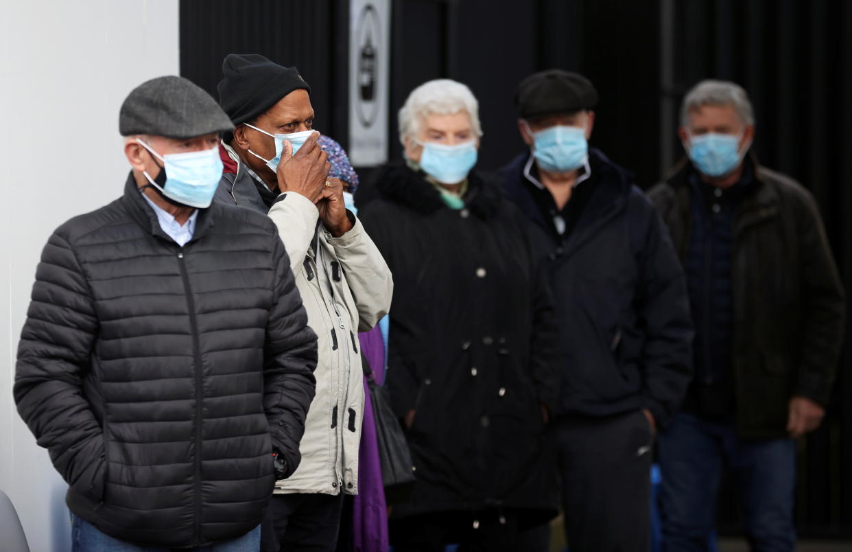 People queue as they wait to receive the COVID-19 vaccine at Crystal Palace Football Club Vaccination Centre, amid the outbreak of the coronavirus disease (COVID-19) in London, Britain February 4, 2021. REUTERS/Hannah McKay