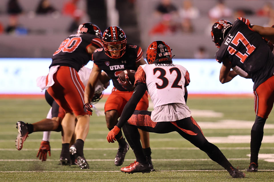 Sep 17, 2022; Salt Lake City, Utah, USA; Utah Utes running back Micah Bernard (2) runs the ball against San Diego State Aztecs cornerback Dezjhon Malone (32) in the second quarter at Rice-Eccles Stadium. Mandatory Credit: Rob Gray-USA TODAY Sports