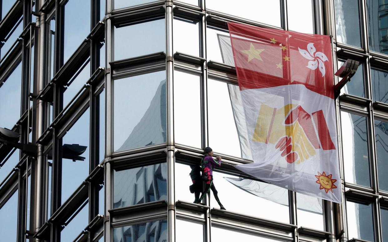 French urban climber Alain Robert climbs the Cheung Kong Centre building in Hong Kong - REUTERS