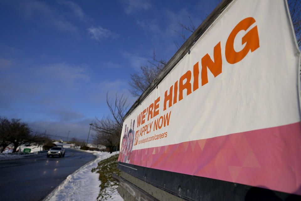 A sign announcing hiring is seen in the parking lot of a Home Depot, Monday, Feb. 22, 2021, in Cockeysville, Md. The number of Americans collecting unemployment benefits slid last week, another sign that the job market continues to recover rapidly from the coronavirus recession. Jobless claims dropped by 24,000 to 400,000 last week, the Labor Department reported Thursday, July 29, 2021. (AP Photo/Julio Cortez)