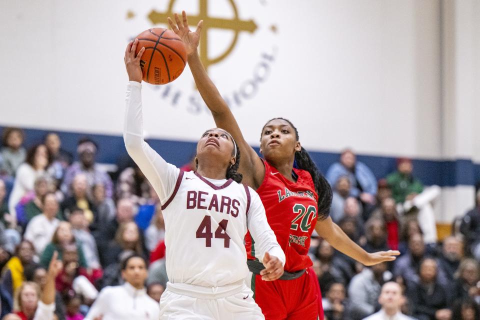 Lawrence North High School senior Natalia Franklin (20) attempts to block a shot by Lawrence Central High School junior Laila Abdurraqib (44) during the first half of an IHSAA Class 4A Sectional semi-final basketball game, Friday, Feb. 2, 2024, at Cathedral High School.