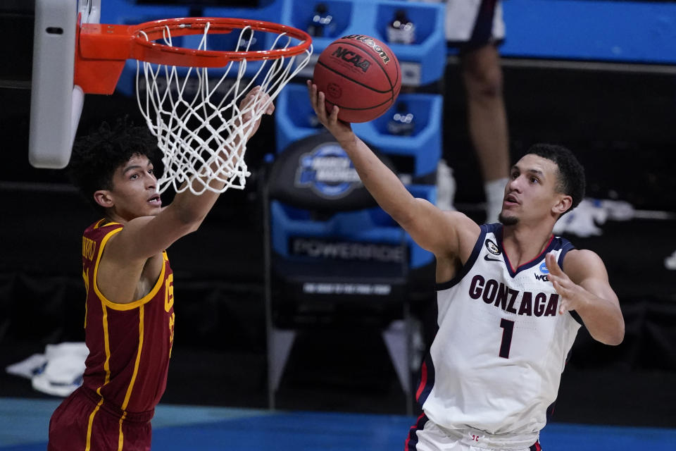 Gonzaga guard Jalen Suggs (1) shoots ahead of Southern California forward Max Agbonkpolo, left, during the second half of an Elite 8 game in the NCAA men's college basketball tournament at Lucas Oil Stadium, Tuesday, March 30, 2021, in Indianapolis. (AP Photo/Darron Cummings)