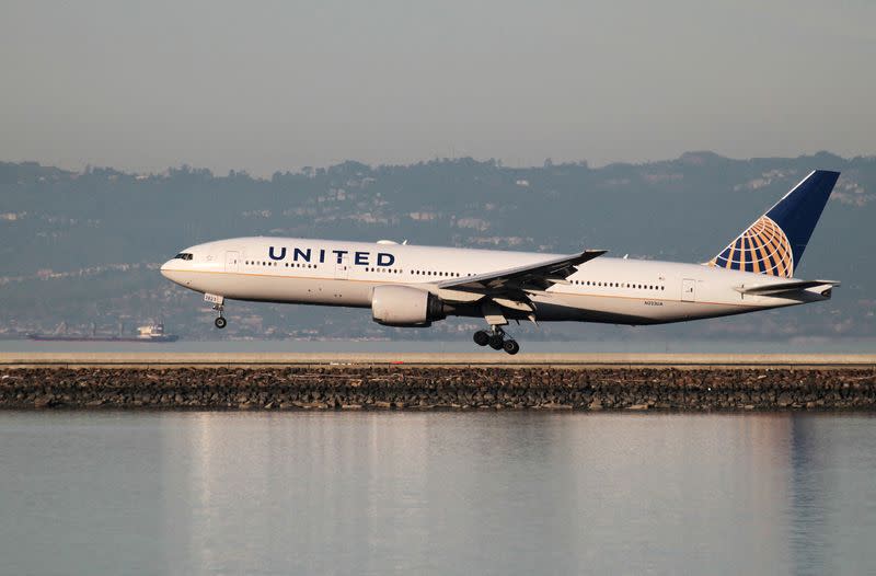 FILE PHOTO: A United Airlines Boeing 777-200 lands at San Francisco International Airport, San Francisco