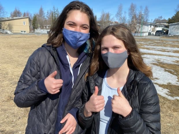 Yellowknife teens Jimena Maule, left, and Juniper Falvo, right, say they're looking forward to being vaccinated, partly so they can help protect their families and communities.