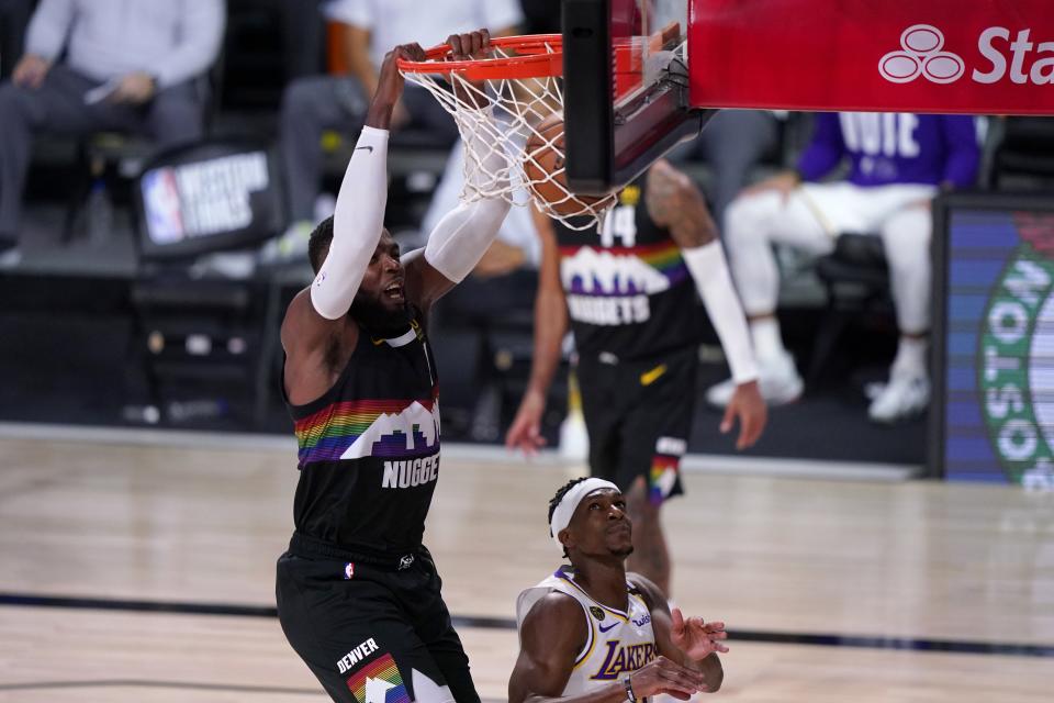 Denver Nuggets forward Paul Millsap (4) dunks over Los Angeles Lakers' Rajon Rondo (9) during the second half of Game 3 of the NBA basketball Western Conference final Tuesday, Sept. 22, 2020, in Lake Buena Vista, Fla. (AP Photo/Mark J. Terrill)